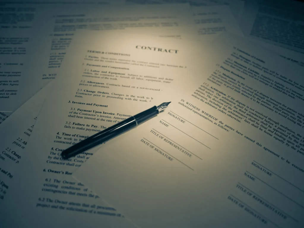 A pen signing a legal contract document